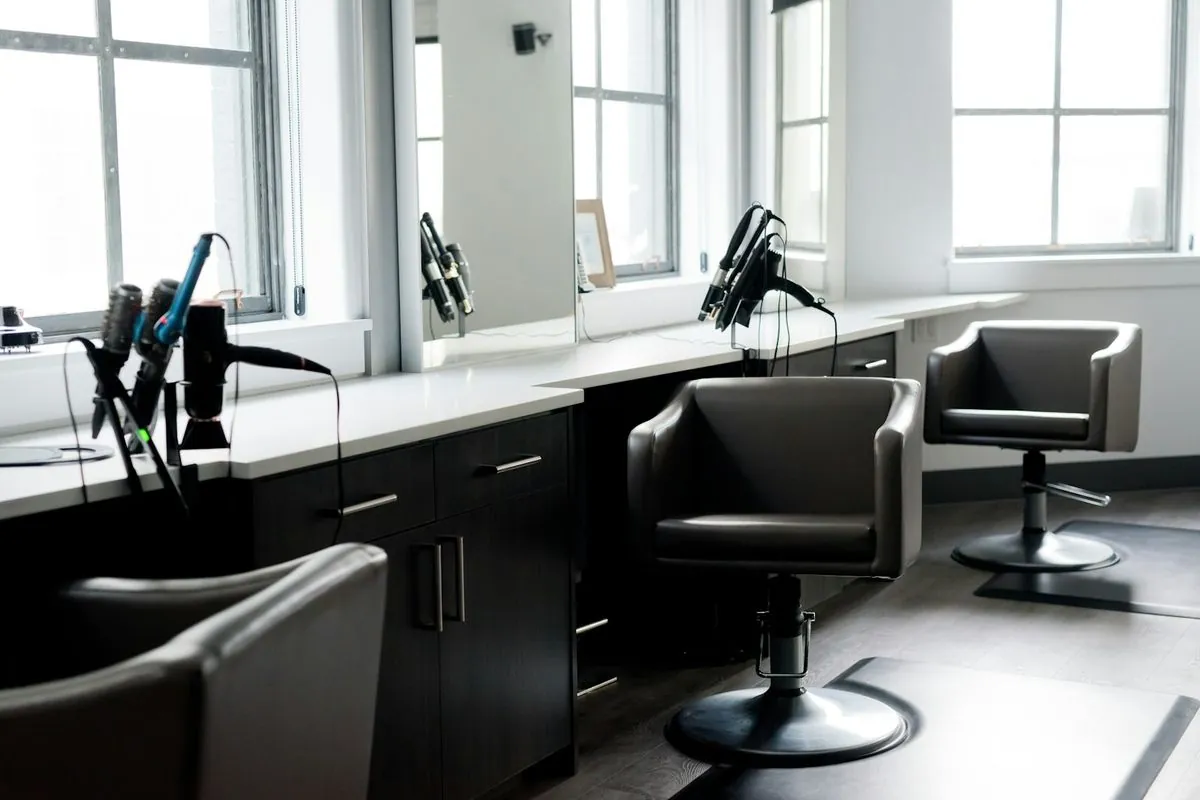 An empty hairdresser’s chair in a salon, a missed appointment